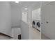 Upstairs hallway view of the laundry room with washer and dryer at 7871 Allscott Way, Raleigh, NC 27612