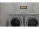 A laundry room featuring a modern washer and dryer with white walls at 7871 Allscott Way, Raleigh, NC 27612