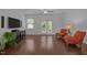 Inviting living room boasts wood floors, lots of seating, and a view to the back at 7871 Allscott Way, Raleigh, NC 27612