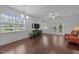 Spacious living room featuring wood floors, large windows, and neutral paint at 7871 Allscott Way, Raleigh, NC 27612