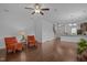 Open-concept living room, with wood floors, leads into the dining room and kitchen at 7871 Allscott Way, Raleigh, NC 27612