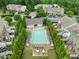 Aerial view of a community pool surrounded by trees, lounge chairs, and tables at 7871 Allscott Way, Raleigh, NC 27612