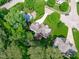 Aerial view of a well-maintained home with lush landscaping and a serene, tree-lined setting at 7929 Pine Timber Dr, Raleigh, NC 27613