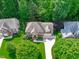 Stunning aerial view of a two-story home surrounded by lush green trees and manicured lawns at 7929 Pine Timber Dr, Raleigh, NC 27613