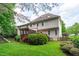 Expansive backyard featuring a wooden deck, lush lawn, and mature trees at 7929 Pine Timber Dr, Raleigh, NC 27613