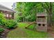 Private backyard oasis featuring a playhouse, lush greenery, and a screened-in porch at 7929 Pine Timber Dr, Raleigh, NC 27613
