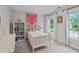 Cozy bedroom with a whimsical decor, filled with natural light from the large windows at 7929 Pine Timber Dr, Raleigh, NC 27613