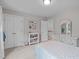 Bright bedroom featuring neutral colors, a closet, and a staircase visible through the doorway at 7929 Pine Timber Dr, Raleigh, NC 27613