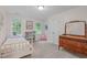 Inviting bedroom with large windows, a comfortable bed, and classic wooden dresser at 7929 Pine Timber Dr, Raleigh, NC 27613