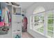 Walk-in closet with built-in shelving and window for natural light at 7929 Pine Timber Dr, Raleigh, NC 27613