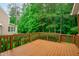 Spacious, stained wood deck with natural wood railings overlooks a lush green landscape at 7929 Pine Timber Dr, Raleigh, NC 27613