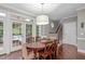 Charming dining area with a view to the screened-in porch and staircase access at 7929 Pine Timber Dr, Raleigh, NC 27613