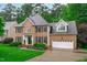 Traditional brick home with manicured lawn, black shutters, white trim, and attached two-car garage at 7929 Pine Timber Dr, Raleigh, NC 27613