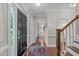 Bright foyer featuring hardwood floors, decorative molding, and a staircase at 7929 Pine Timber Dr, Raleigh, NC 27613