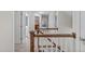 Upstairs hallway featuring neutral walls, white trim, and carpeted floors with wood banister at 7929 Pine Timber Dr, Raleigh, NC 27613