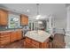 Updated kitchen with a central island, stainless appliances, and access to the dining area at 7929 Pine Timber Dr, Raleigh, NC 27613