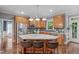 Beautiful kitchen island with barstool seating and stainless steel appliances throughout at 7929 Pine Timber Dr, Raleigh, NC 27613