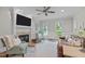Cozy living room with a fireplace, comfortable seating, and ample natural light at 7929 Pine Timber Dr, Raleigh, NC 27613
