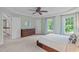 Spacious main bedroom featuring a ceiling fan, large windows, and a dresser at 7929 Pine Timber Dr, Raleigh, NC 27613