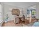 Comfortable office space featuring a wooden desk, warm lighting, and hardwood floors at 7929 Pine Timber Dr, Raleigh, NC 27613