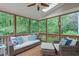 Relaxing screened-in porch with comfortable seating and scenic wooded views at 7929 Pine Timber Dr, Raleigh, NC 27613