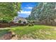 Expansive back yard with lush green grass, mature trees, and privacy fence at 8504 Delavan Cir, Raleigh, NC 27613