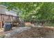 Private backyard oasis featuring a deck, grill, outdoor dining, a fire pit, and a hot tub at 8504 Delavan Cir, Raleigh, NC 27613