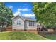 Backyard view with wooden fence, well-maintained lawn, deck with grill and outdoor dining area at 8504 Delavan Cir, Raleigh, NC 27613