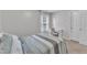 Neutral colored bedroom with a white desk set by the window and a queen sized bed at 8504 Delavan Cir, Raleigh, NC 27613