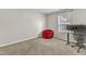 Cozy bedroom with a red beanbag chair, a desk, and a window bringing natural light into the room at 8504 Delavan Cir, Raleigh, NC 27613