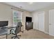 Neutral bedroom featuring a desk, TV, dresser and double door closet at 8504 Delavan Cir, Raleigh, NC 27613