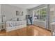 Bright bedroom featuring a daybed, a treadmill, and a large window with natural light at 8504 Delavan Cir, Raleigh, NC 27613