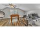 Spacious bonus room with ceiling fan, wood floors, a hanging chair, foosball, and a desk at 8504 Delavan Cir, Raleigh, NC 27613