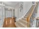 Bright and open foyer with hardwood floors and a staircase leading to the upper level at 8504 Delavan Cir, Raleigh, NC 27613
