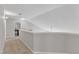 Upstairs hallway with light-colored walls and carpet. A glimpse of a game room can be seen in the background at 8504 Delavan Cir, Raleigh, NC 27613