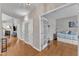 Hallway featuring hardwood floors and open doorway views of other rooms at 8504 Delavan Cir, Raleigh, NC 27613