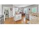 Bright kitchen featuring granite countertops, stainless steel appliances, island, and an adjacent dining area at 8504 Delavan Cir, Raleigh, NC 27613
