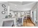 Kitchen with breakfast bar, granite counters, white cabinets, and stainless steel appliances at 8504 Delavan Cir, Raleigh, NC 27613