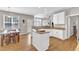 Kitchen with breakfast bar, granite counters, white cabinets, and stainless steel appliances at 8504 Delavan Cir, Raleigh, NC 27613