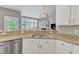 Updated kitchen with granite counters, stainless dishwasher and a view to living room at 8504 Delavan Cir, Raleigh, NC 27613