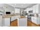 Kitchen with breakfast bar, granite counters, white cabinets, and stainless steel appliances at 8504 Delavan Cir, Raleigh, NC 27613