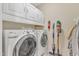 Functional laundry room with washer, dryer, cabinets, and storage solutions at 8504 Delavan Cir, Raleigh, NC 27613