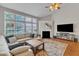 Bright living room with vaulted ceiling, fireplace, and large windows at 8504 Delavan Cir, Raleigh, NC 27613