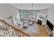 Bright and airy living room showcasing a fireplace, a large sofa, and natural light from large windows at 8504 Delavan Cir, Raleigh, NC 27613