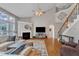Living room showcasing hardwood floors, fireplace, and staircase to the second floor at 8504 Delavan Cir, Raleigh, NC 27613