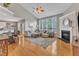 Bright living room with vaulted ceiling, fireplace, and large windows overlooking the backyard at 8504 Delavan Cir, Raleigh, NC 27613