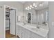 Spacious main bathroom with a double sink vanity, a glass shower, and a walk-in closet at 8504 Delavan Cir, Raleigh, NC 27613