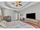 Comfortable main bedroom with hardwood floors, a tray ceiling, and ample closet space at 8504 Delavan Cir, Raleigh, NC 27613