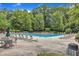 Expansive community pool surrounded by lounge chairs and umbrellas, perfect for relaxing and soaking up the sun at 8504 Delavan Cir, Raleigh, NC 27613