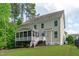 Spacious backyard showcasing a screened porch and ample green space perfect for outdoor entertaining and relaxation at 851 Dotson Way, Apex, NC 27523